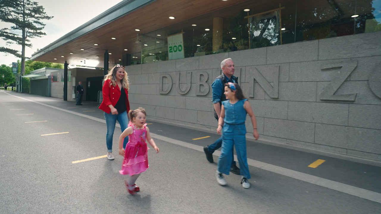 a man woman and their two children walking outside dublin zoo 