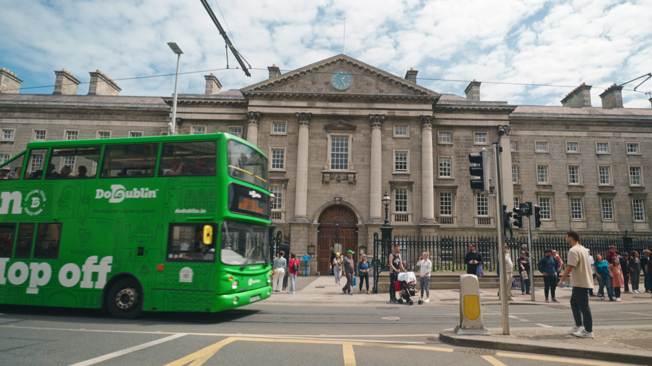 the hop on hop house bus passing a building in the city